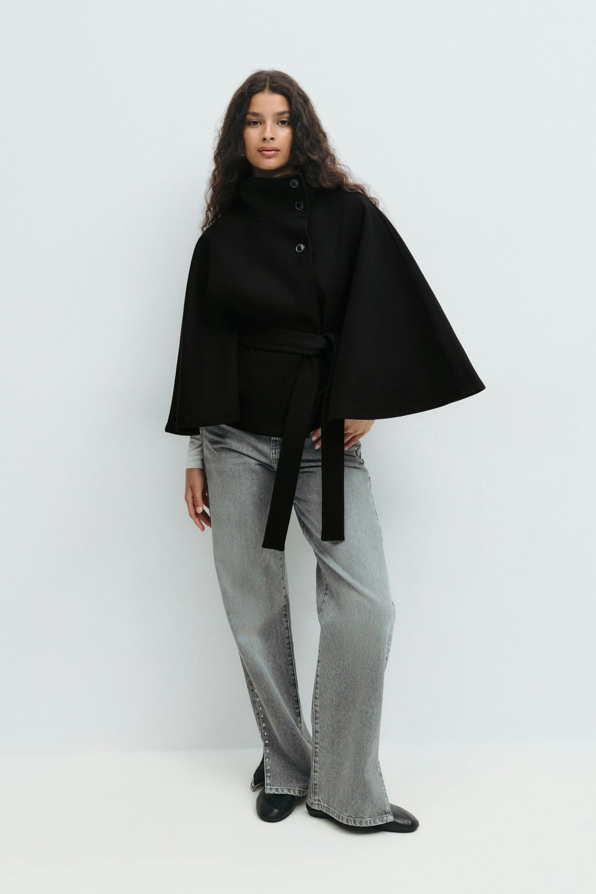 Black belted cape jacket, full length front view on model