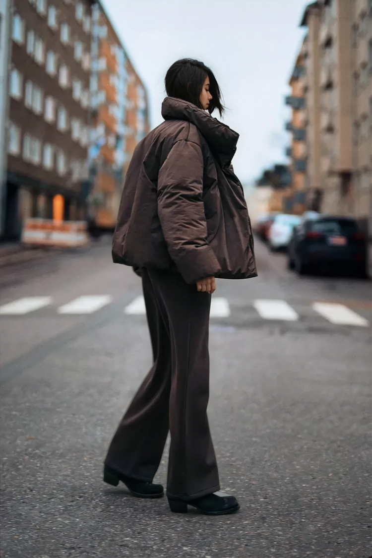 Brown wrap puffer jacket on model, side view on street
