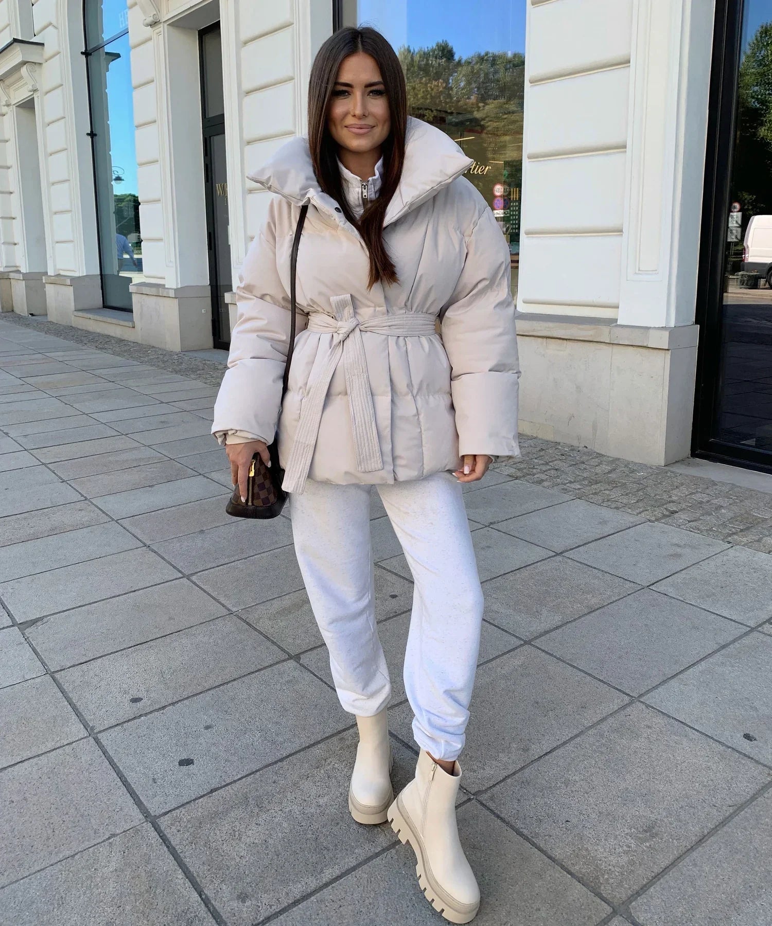 Oatmeal belted puffer jacket, full length front view on model