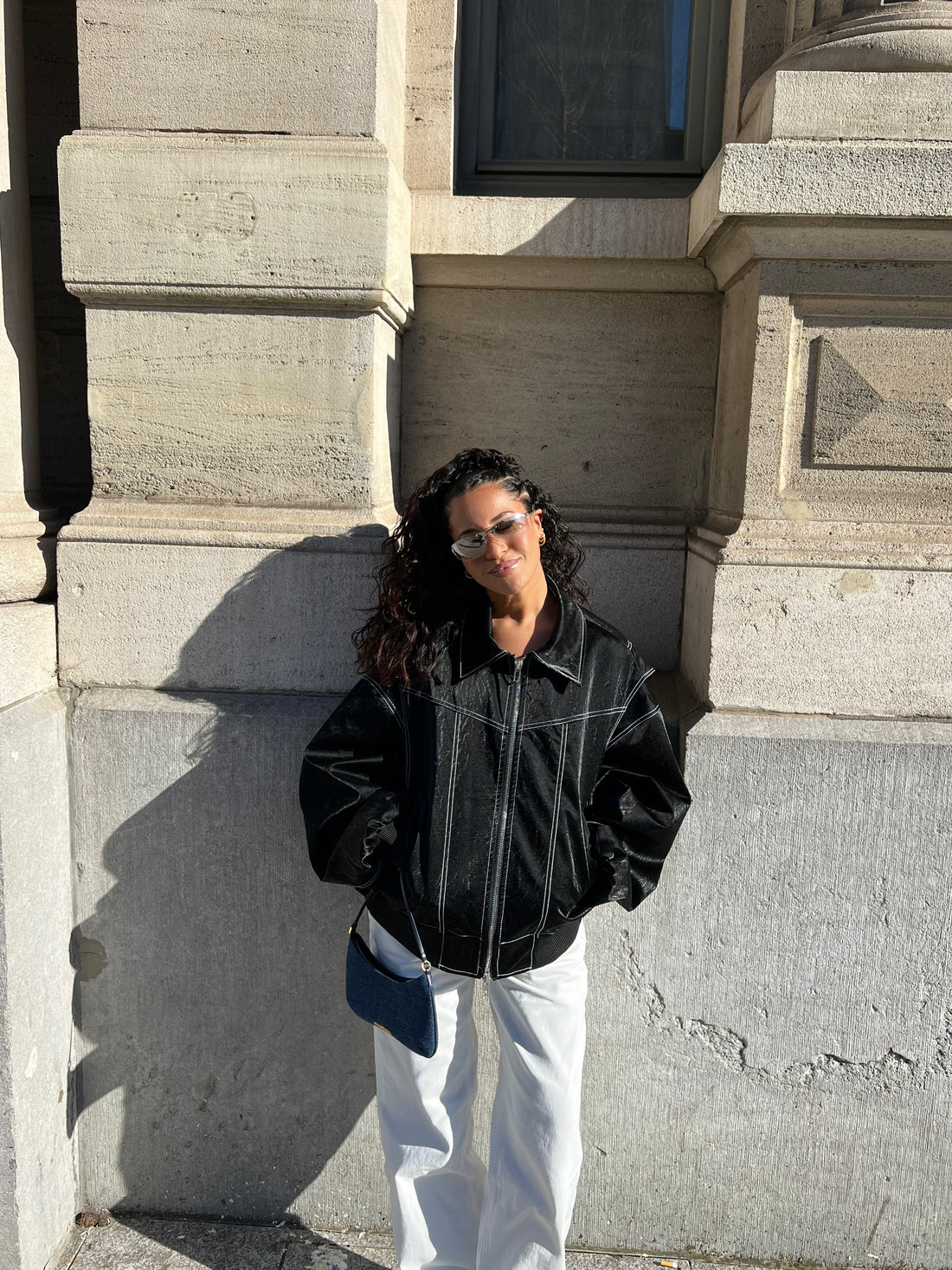 Black oversized contrast-stitch jacket over white trousers, front view