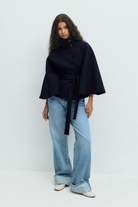 Midnight blue belted cape jacket, full length front view on model