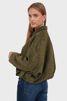 Olive green suede bomber jacket, side view on model