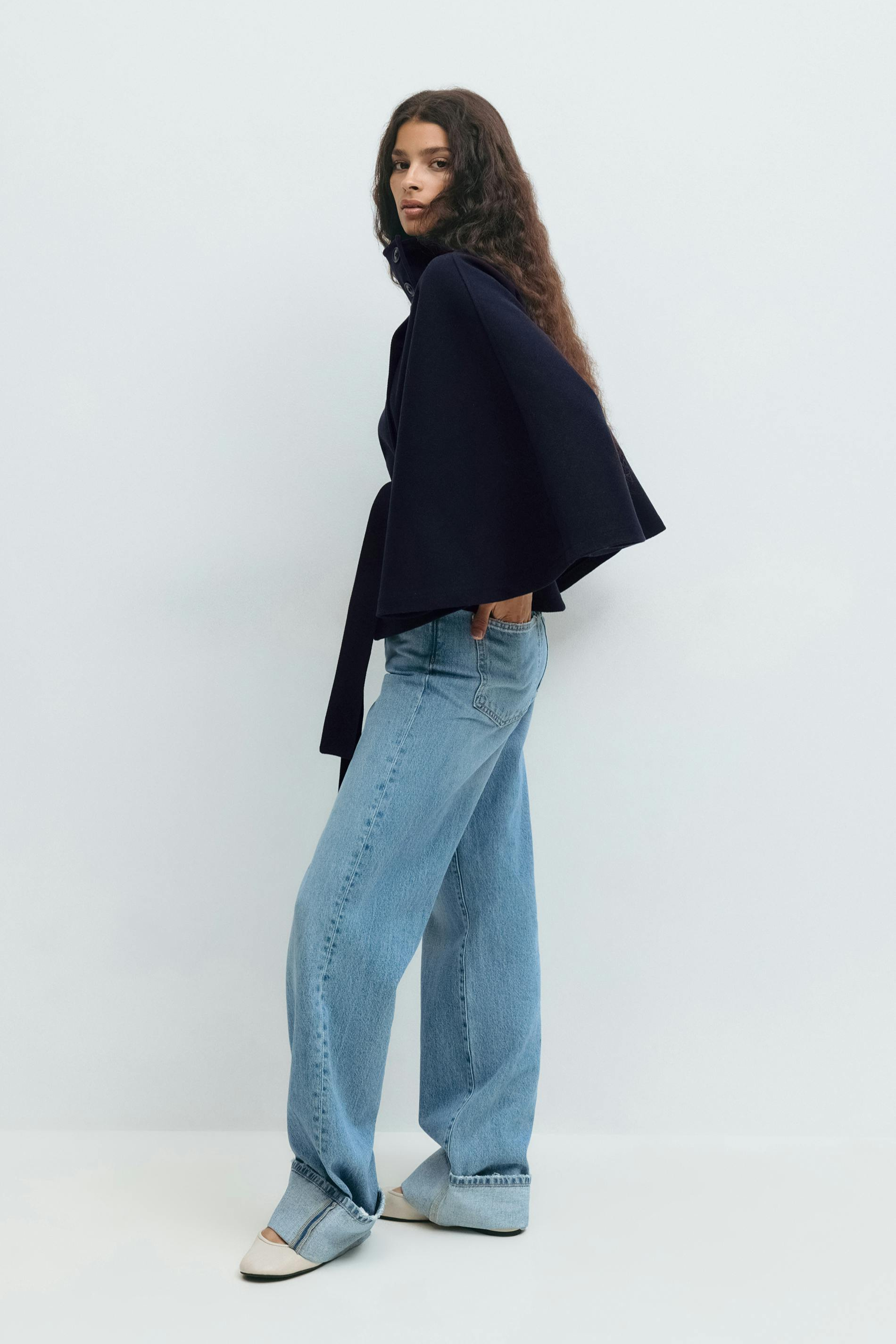 Midnight blue belted cape jacket, side view on model