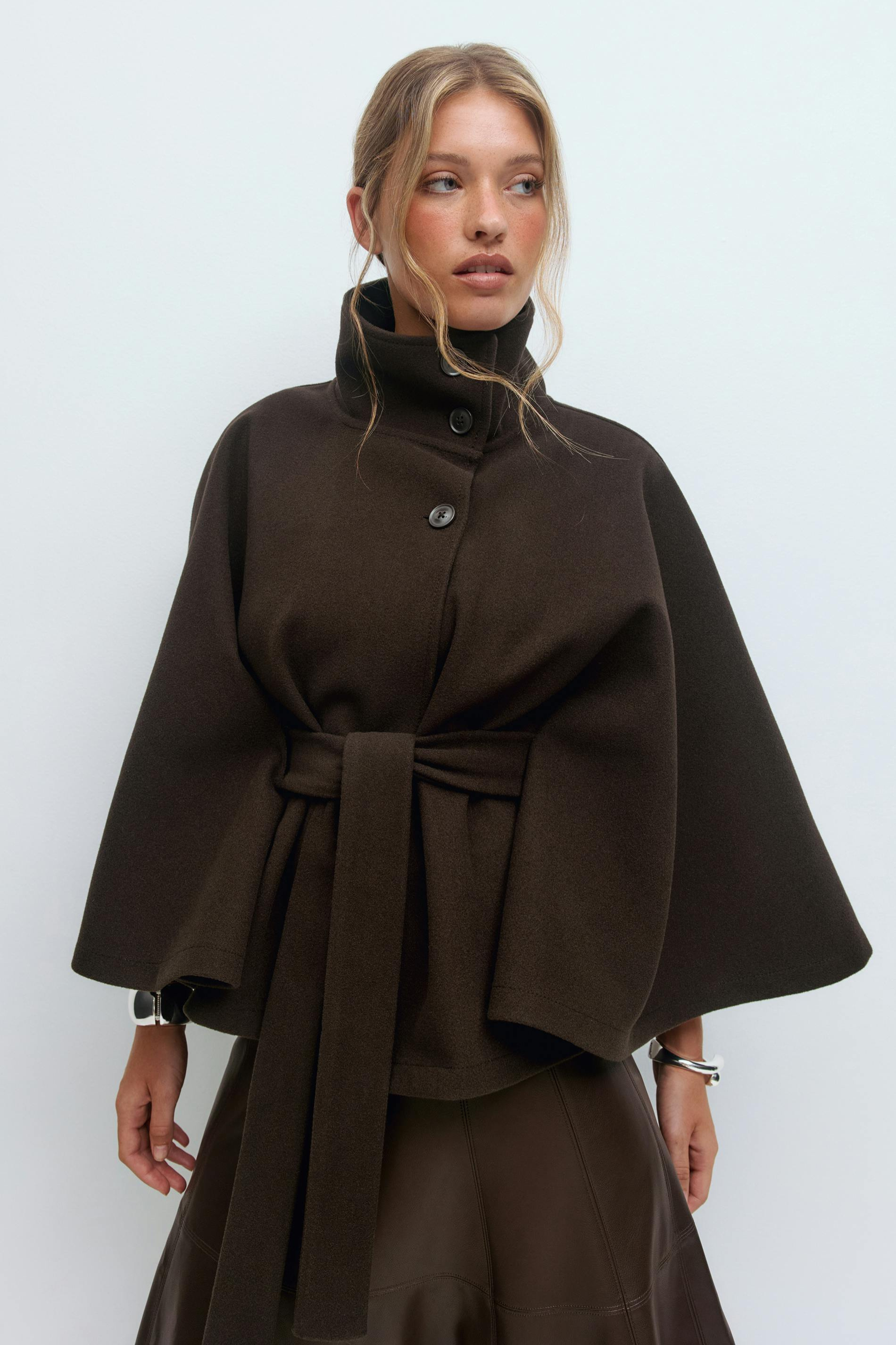 Brown belted cape jacket, close-up front view on model