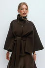 Brown belted cape jacket, close-up front view on model