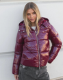 Wine red glossy hooded puffer jacket, front view on model