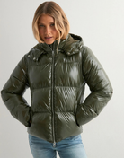 Close-up of green glossy hooded puffer jacket on model