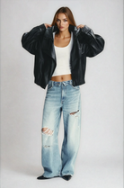Black oversized leather jacket on model, front view
