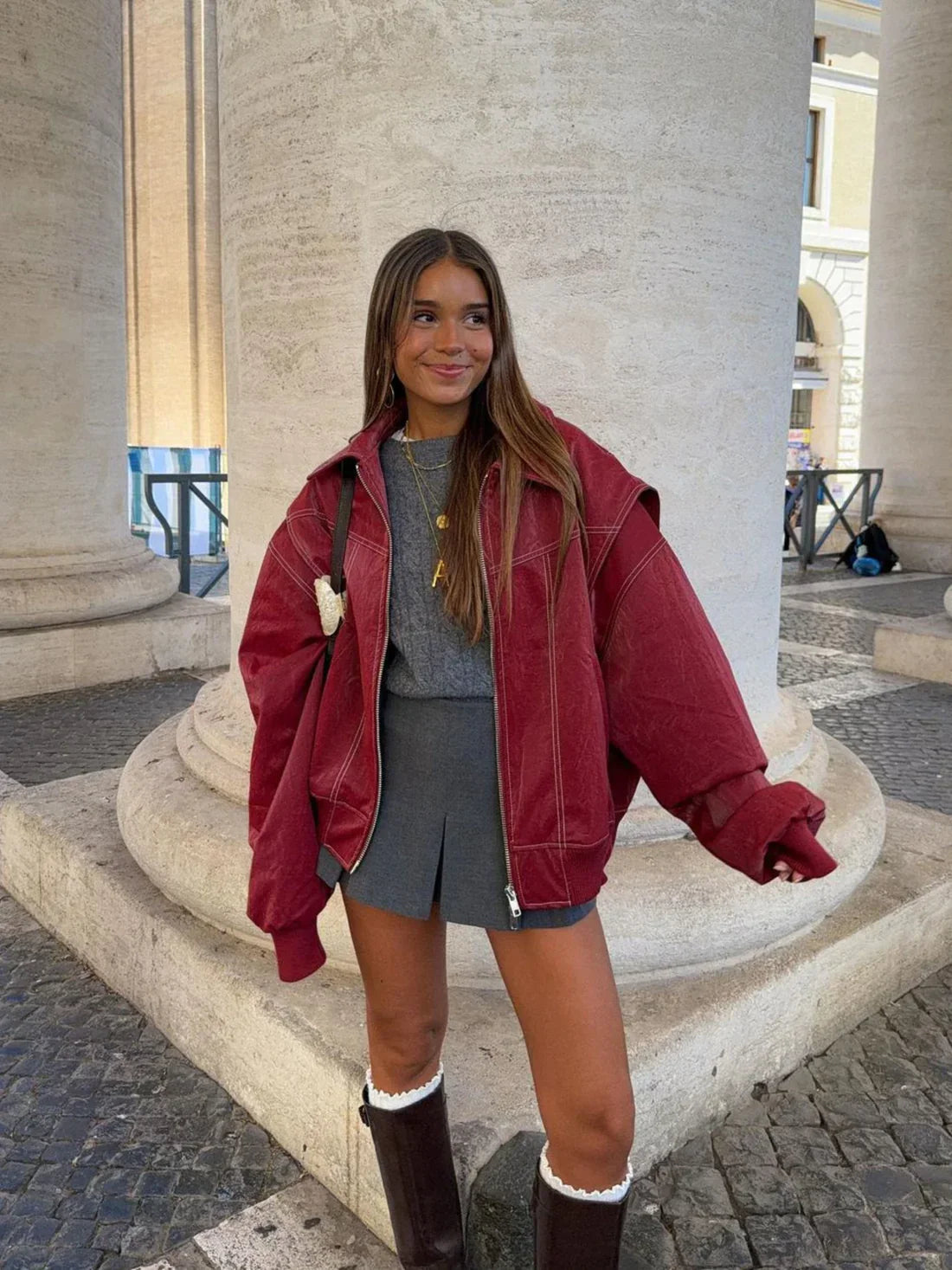 Red oversized contrast-stitch jacket over grey skirt, front view on model