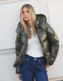 Green glossy hooded puffer jacket, front view on model