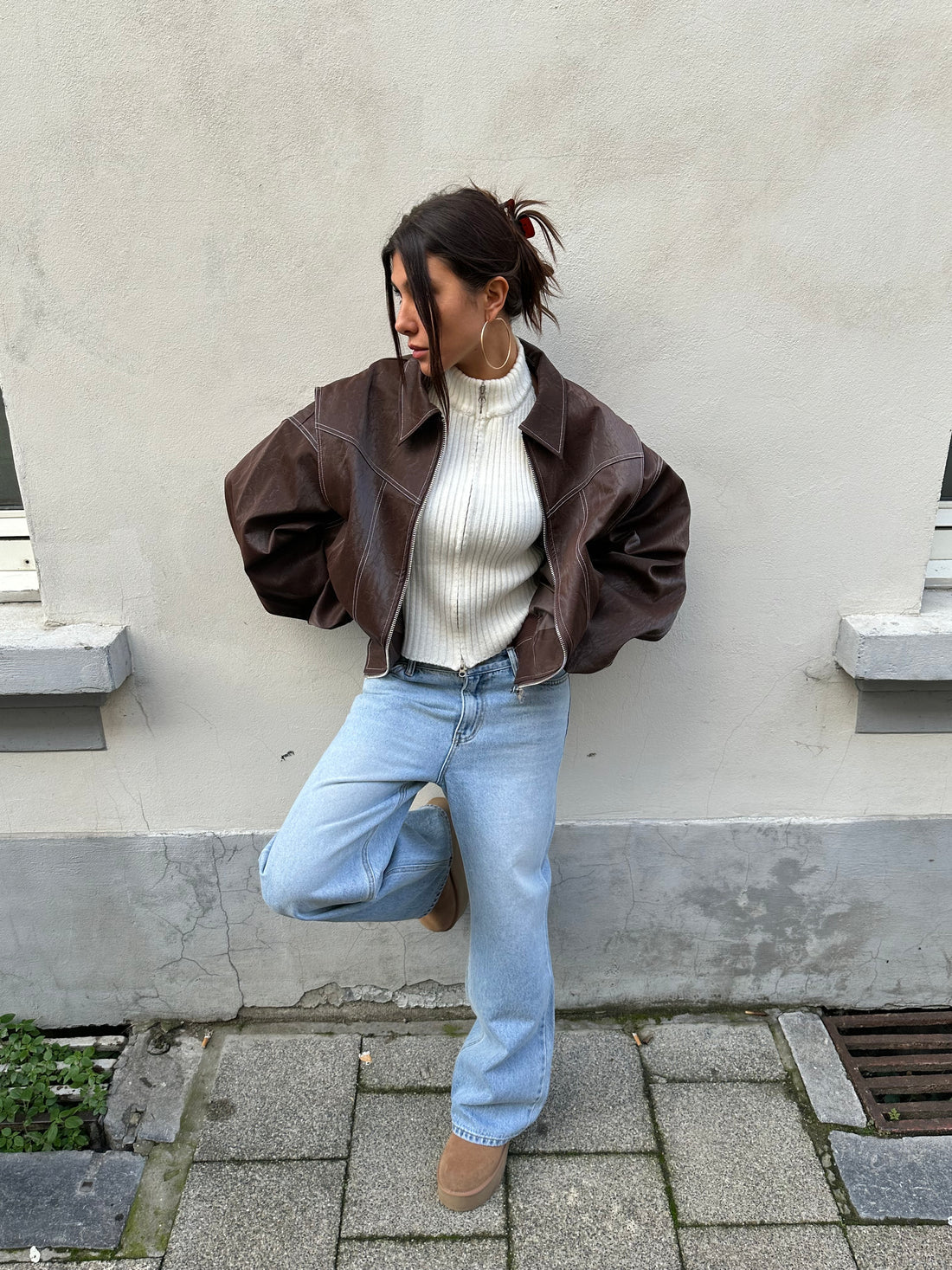 Brown oversized contrast-stitch jacket over jeans, front view