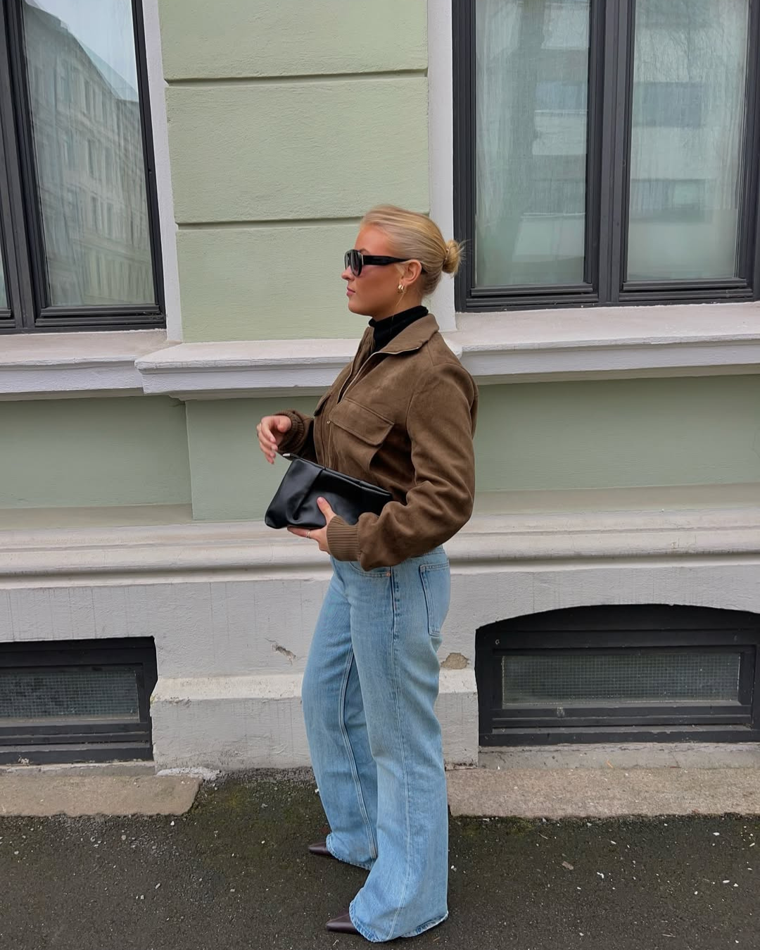 Brown suede bomber jacket, full length side view on model