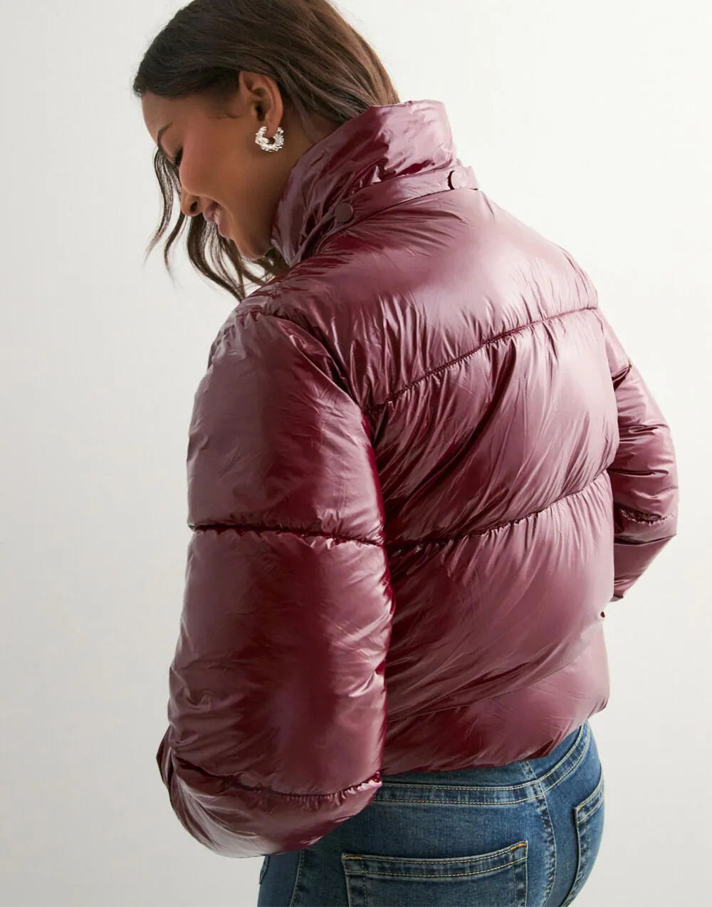 Wine red glossy hooded puffer jacket, back view on model