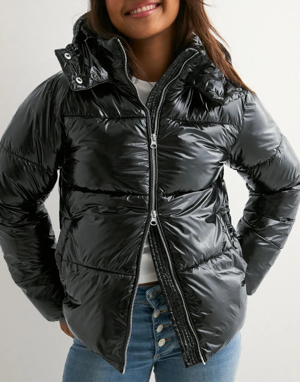 Close-up of black puffer jacket zip and inner knit trim