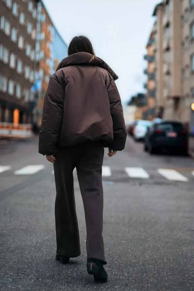 Brown wrap puffer jacket on model, back view walking