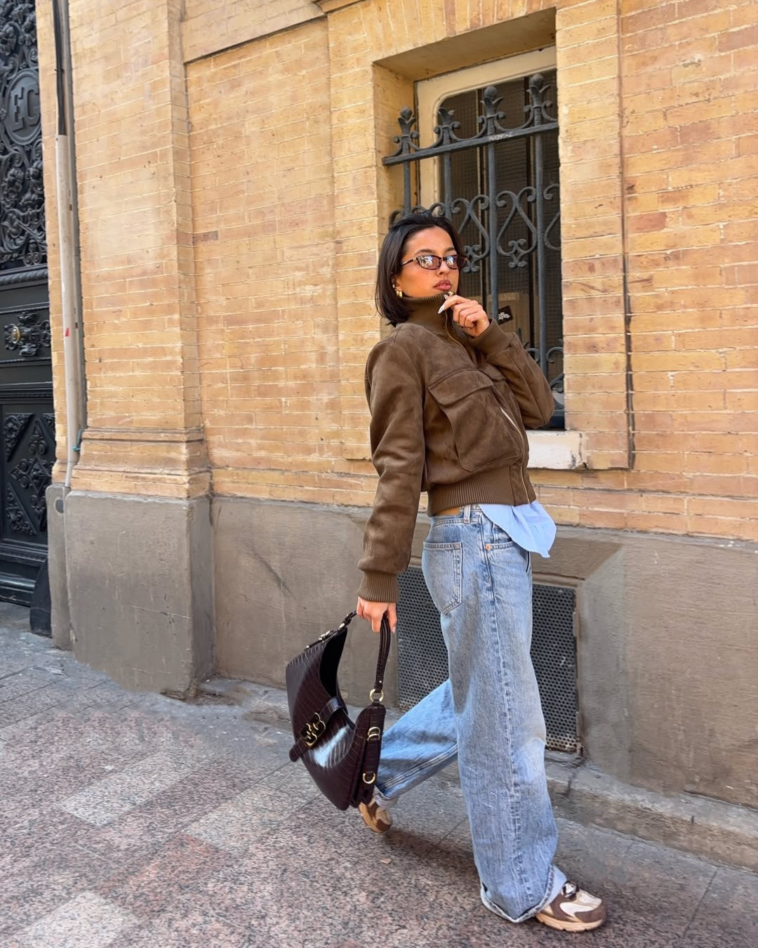 Brown suede bomber jacket, model walking, side view