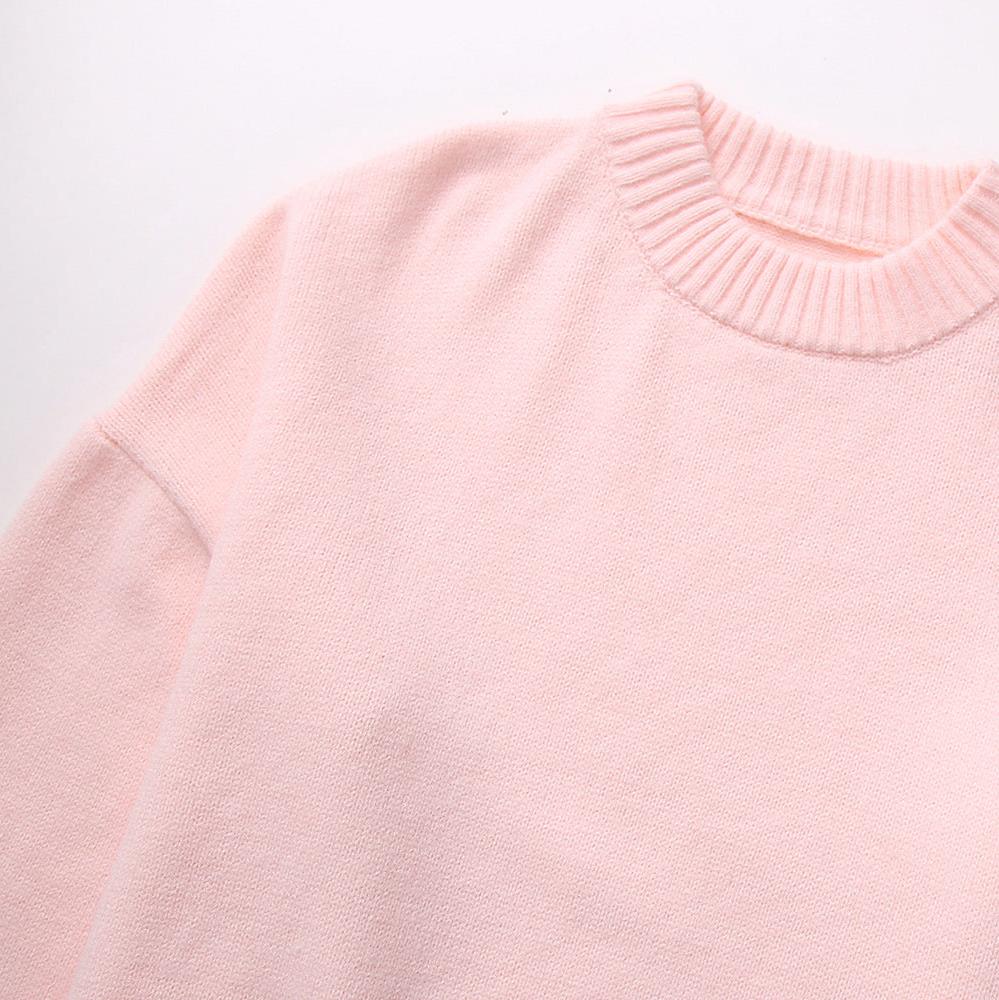 Close-up of pink jumper knit fabric and crew neckline