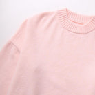 Close-up of pink jumper knit fabric and crew neckline