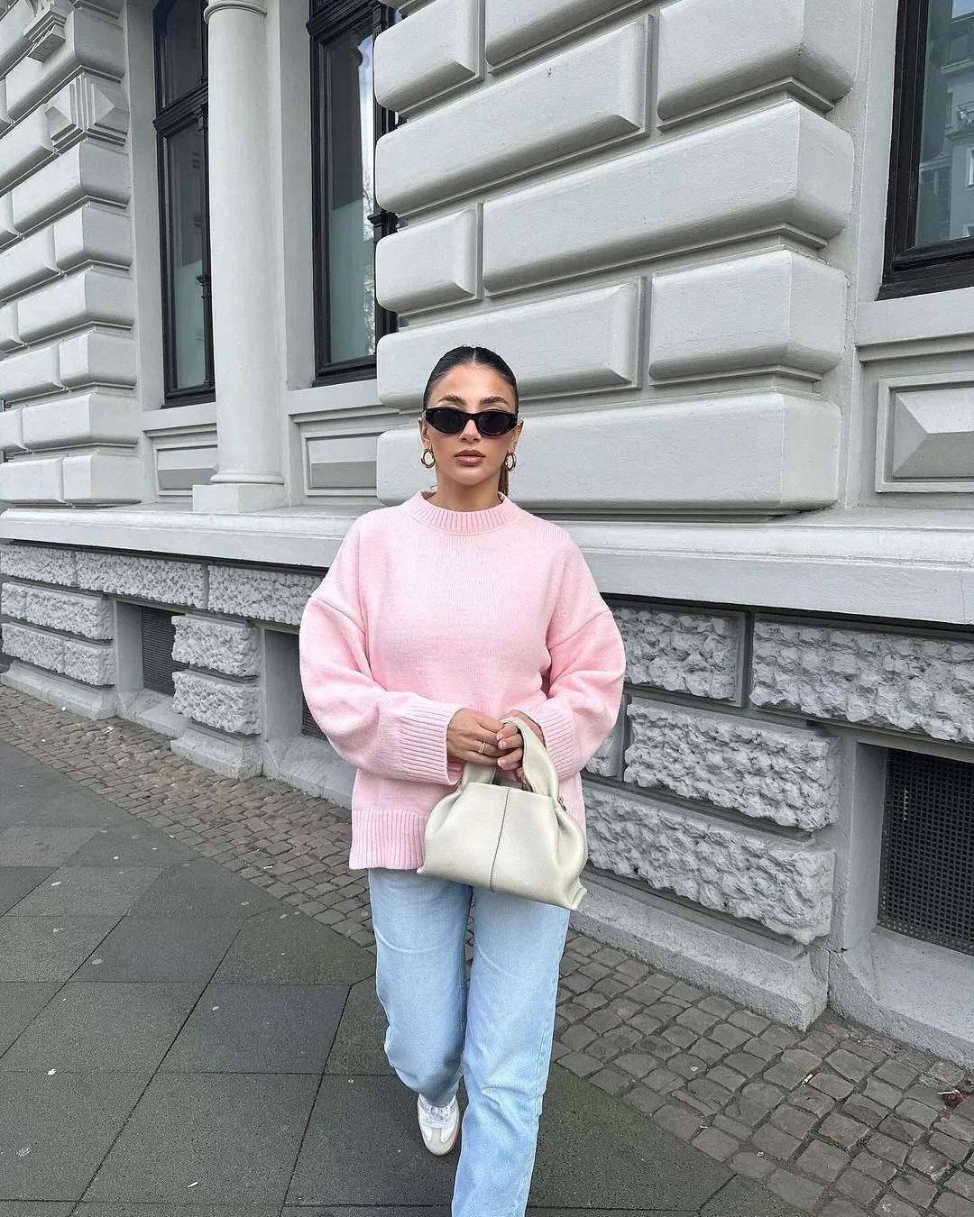 Pink oversized jumper with jeans, full-length front view on model