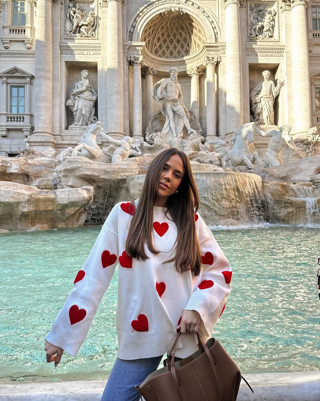 Ivory jumper with red heart print, front view by fountain