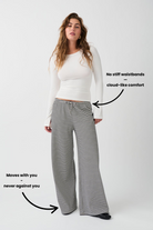 Text graphic showing black and white striped wide-leg trousers on model