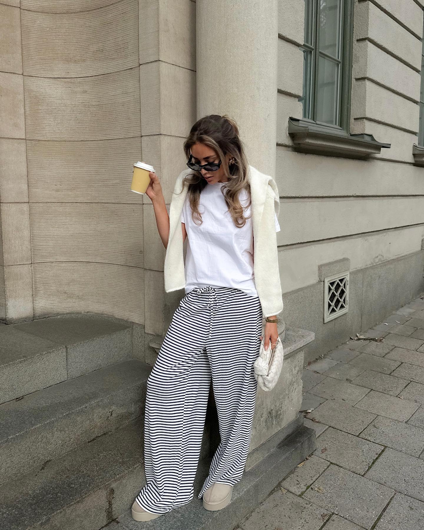 Black and white striped wide-leg trousers, front view on model