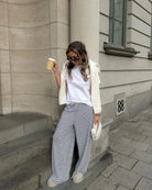 Black and white striped wide-leg trousers, front view on model