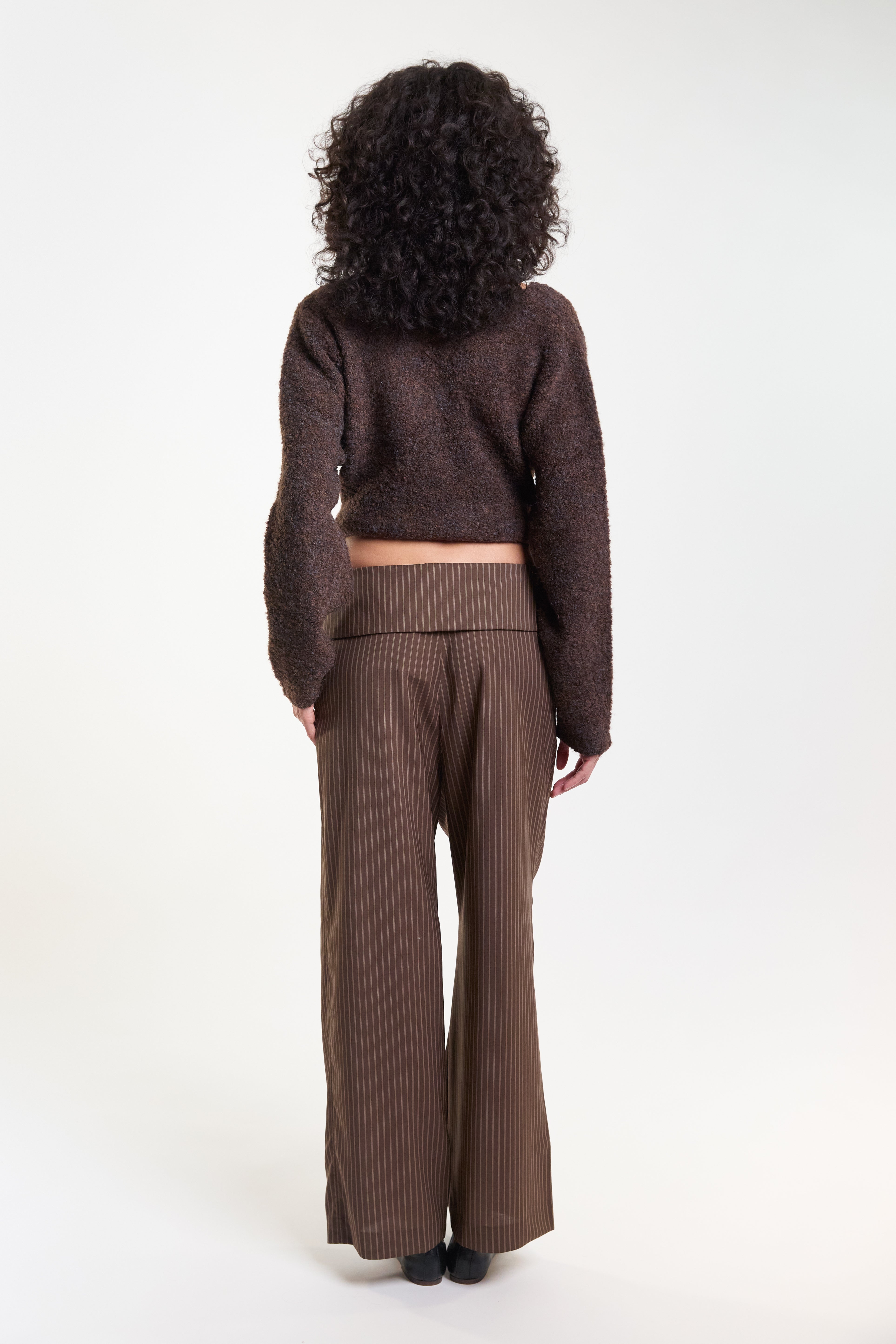 Brown pinstripe tailored trousers, back view on model