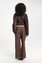 Brown pinstripe tailored trousers, back view on model