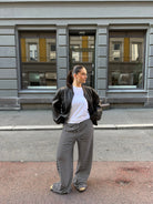 Black and white striped wide-leg trousers, street style on model