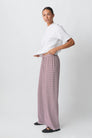 Red and white striped wide-leg trousers, side view on model