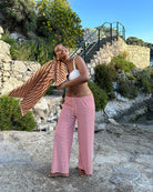 Red and white striped wide-leg trousers, beach lifestyle shot on model