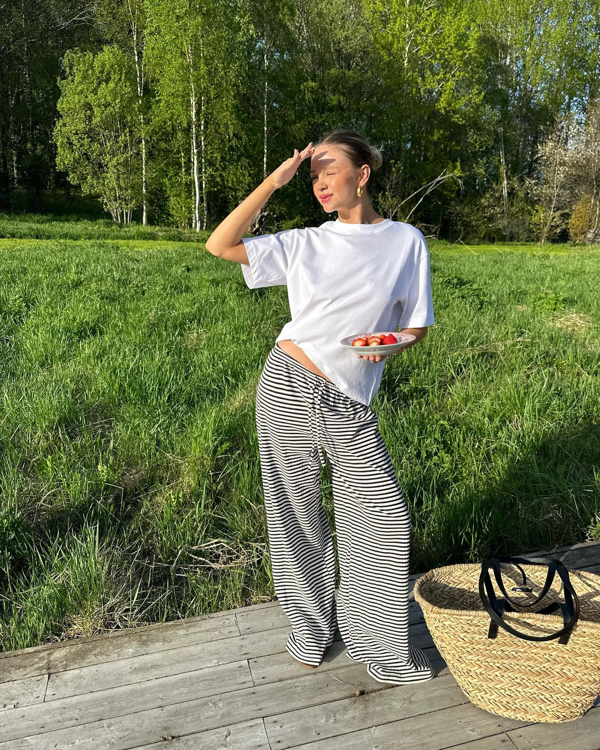 Black and white striped wide-leg trousers, outdoor lifestyle shot on model