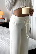 Close-up of ivory lounge trousers, drawstring waistband detail