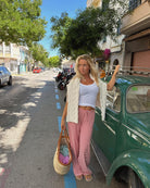 Red and white striped wide-leg trousers, street style on model
