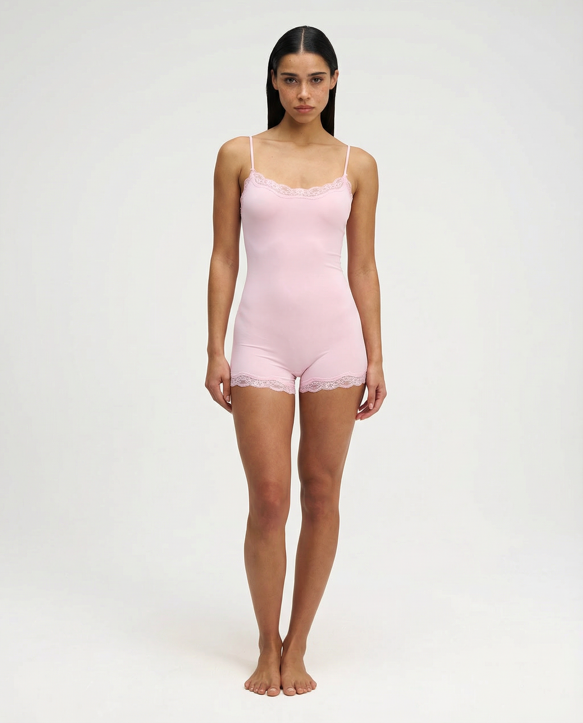 Soft pink lace-trim romper, full length front view on model