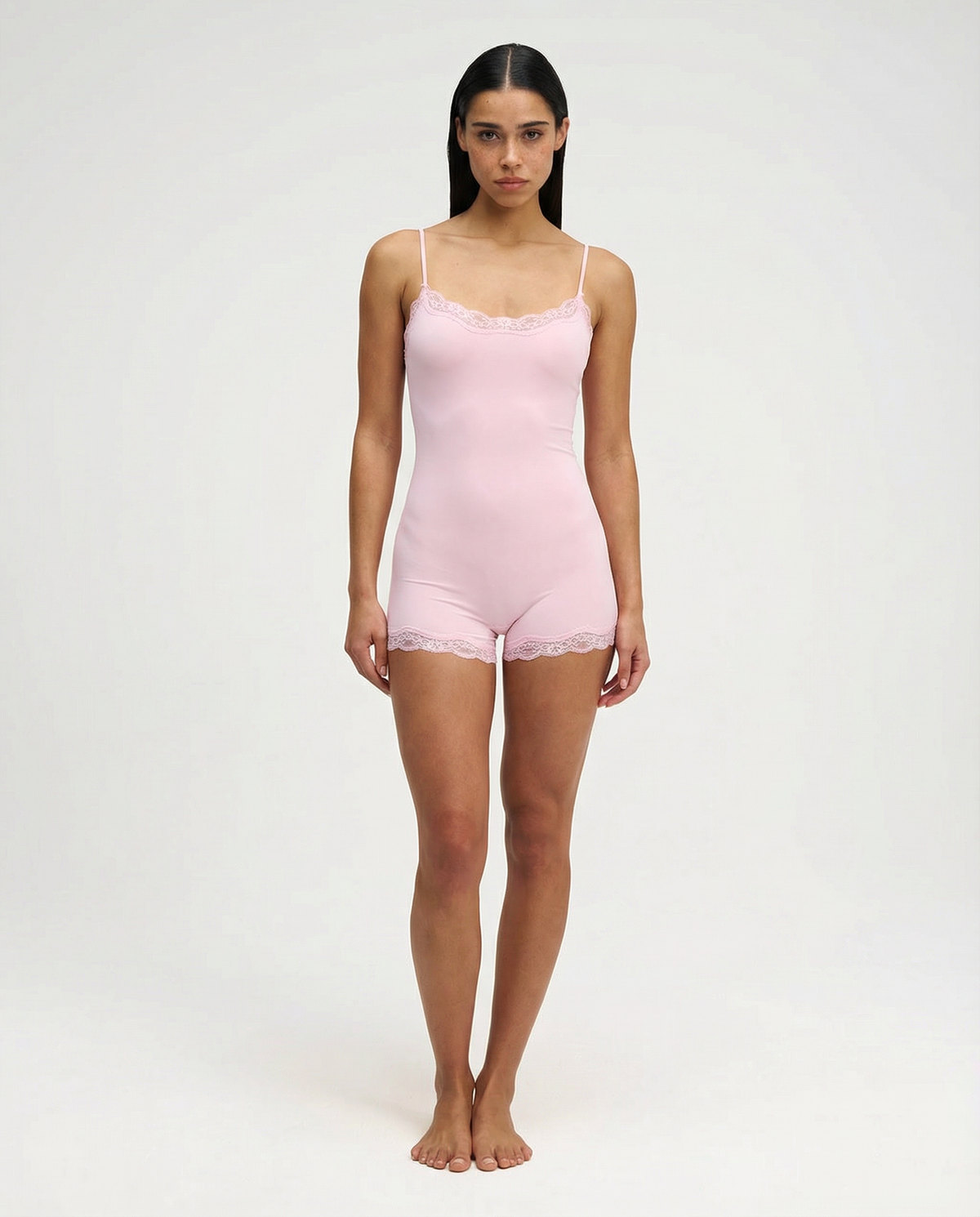 Soft pink lace-trim romper, full length front view on model