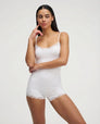 White lace-trim romper, front view on model