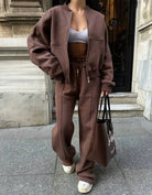Brown zip-up hoodie and joggers set, model standing outdoors