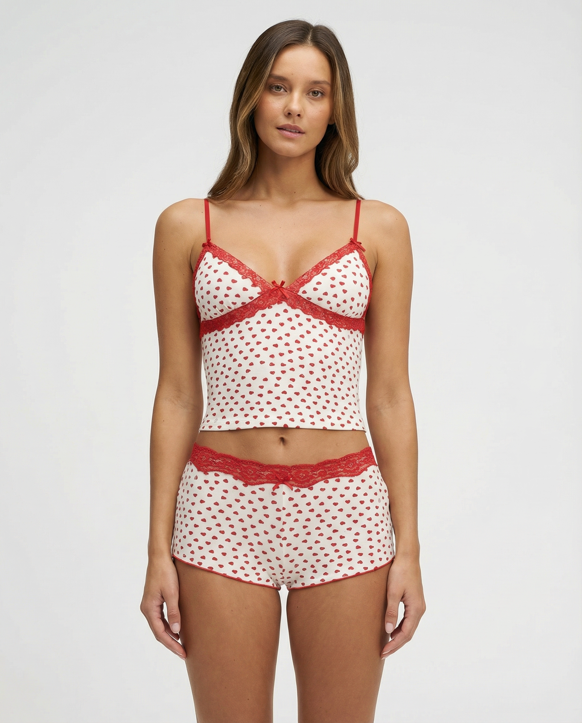 Ivory pyjama set with red heart print and lace trim, front view on model