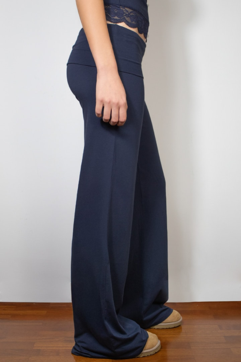 Navy wide-leg joggers with fold-over waistband, side view on model