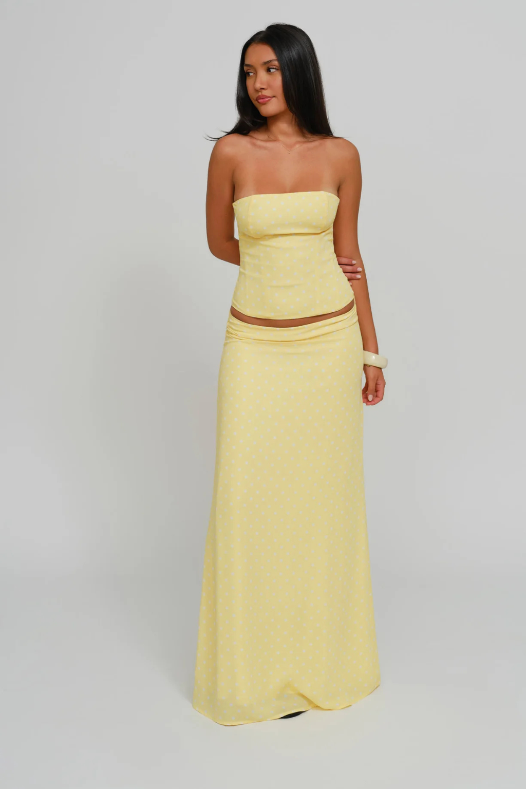 Lemon dot corset top and wrap maxi skirt, side view on model