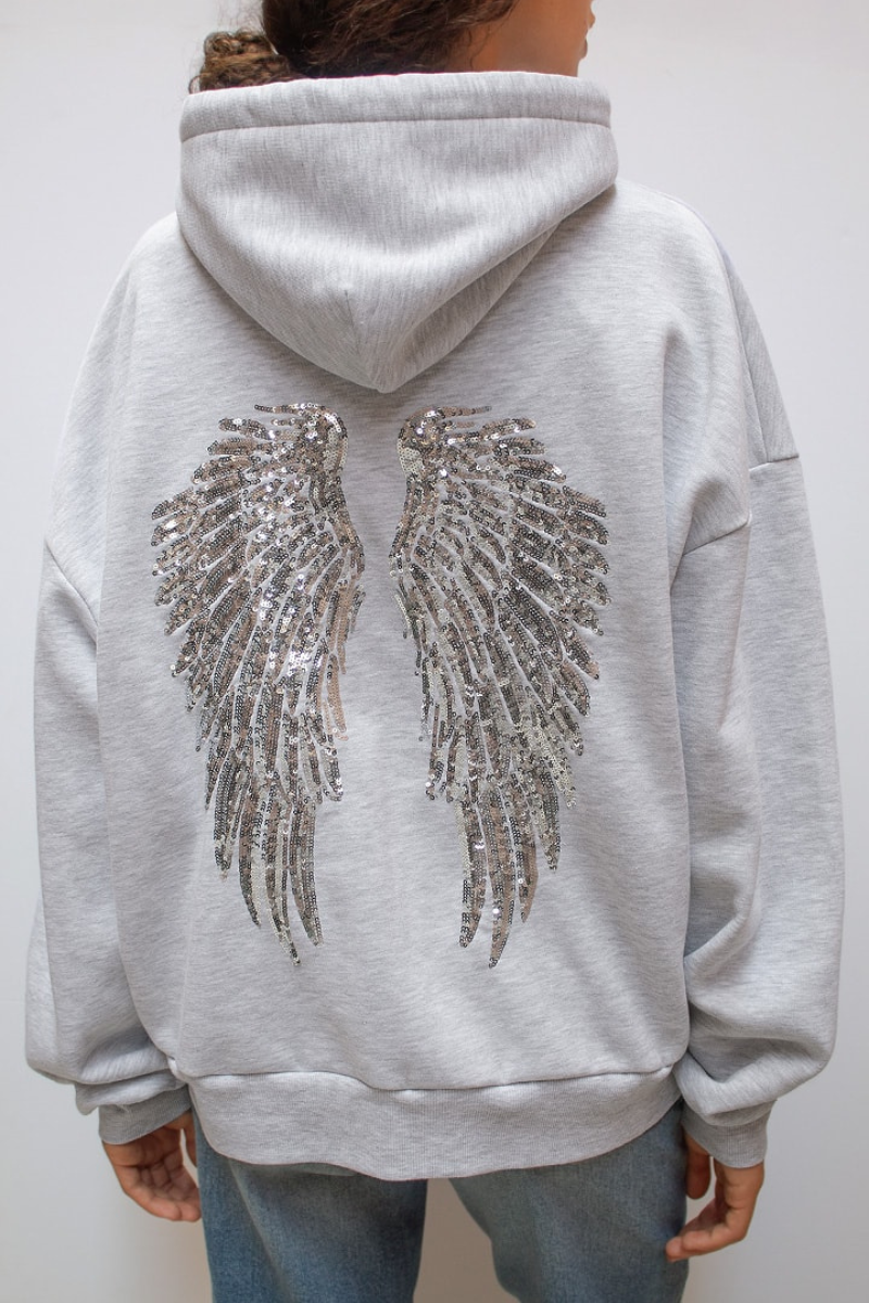 Detail of sequin angel wings on back of grey hoodie