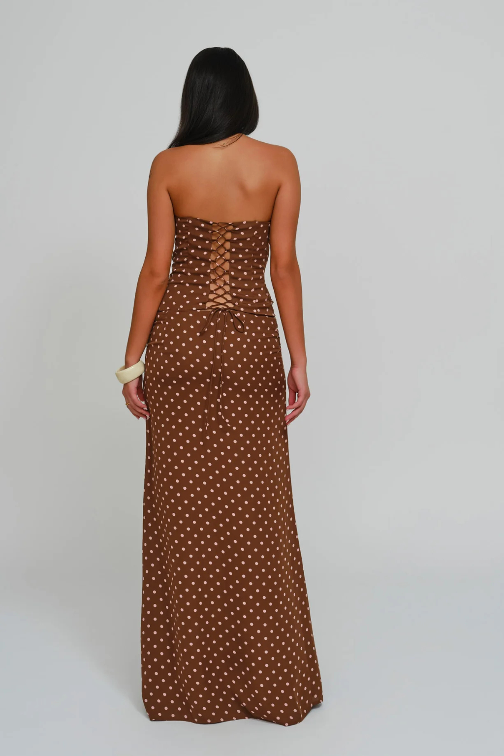 Cocoa dot lace-up corset top and wrap maxi skirt, back view on model