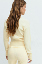 Yellow knitted cardigan and trousers set, close crop back view