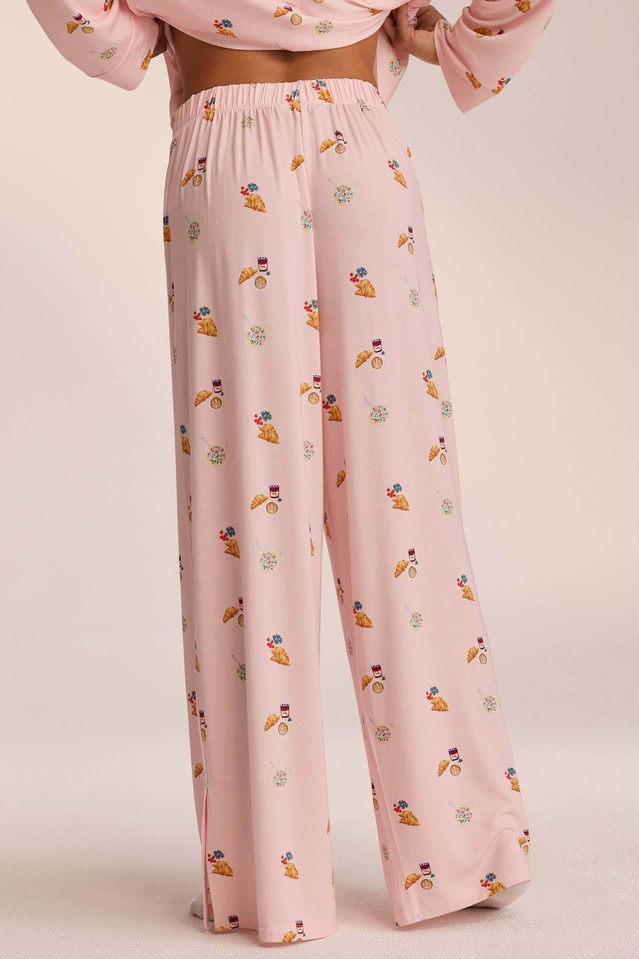 Close-up of pink breakfast-print pyjama trousers, back view on model