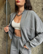 Close-up of the grey zip-up hoodie and joggers set on model