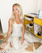 White stripe halter top and wide-leg trousers set, kneeling front view