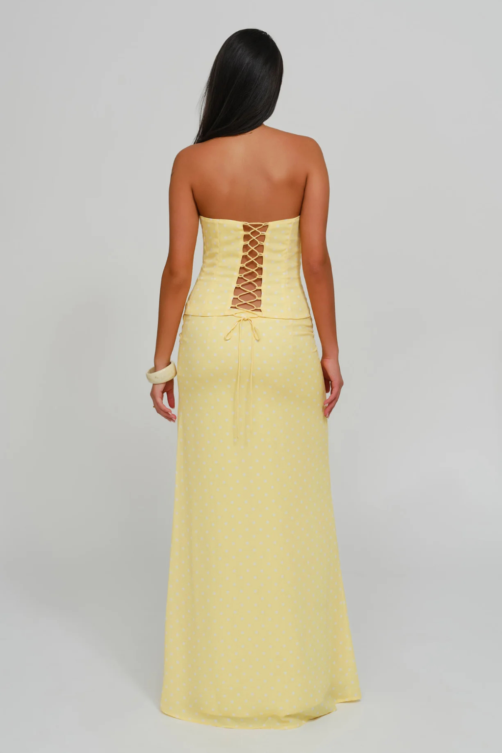 Lemon dot lace-up corset top and wrap maxi skirt, back view on model