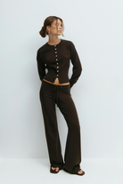 Brown knitted cardigan and trousers set on model, front view